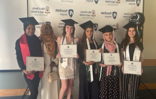 tri-alpha students smiling with grad caps